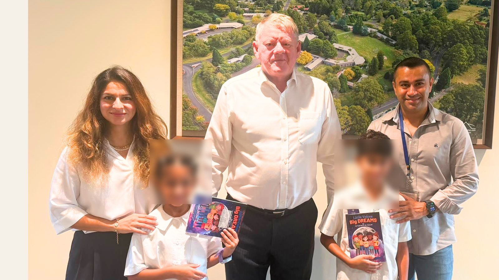 Children gifting a copy of the original and final book to their school Principal
